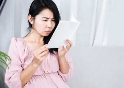 Person squinting or straining eyes while trying to focus on a near or distant object.