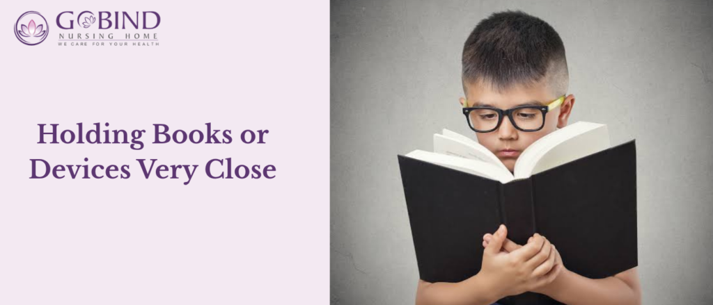 A child who brings books, homework, or digital devices unusually close to their face may be struggling to see small details clearly.